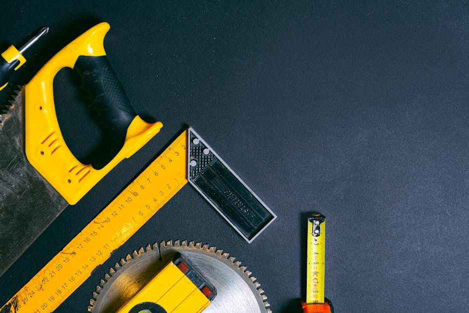 Flat lay of construction tools with copy space on a dark background.