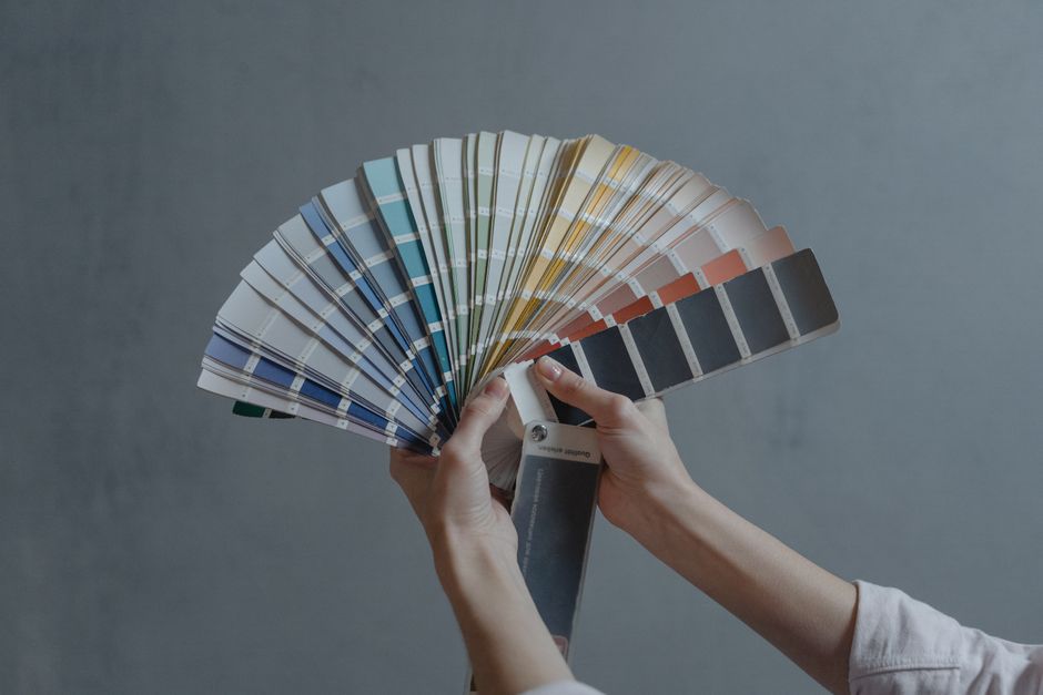 A fan of designer color palette swatches used to plan a brand color scheme.